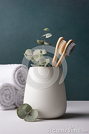 Eco-friendly bamboo toothbrushes in a white holder Stock Photo