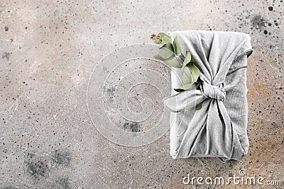 Eco-friendly fabric reusable gift packaging with eucalyptus. Sustainable gift wrapping. Flat lay Stock Photo