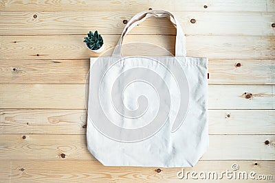 Eco friendly jeans shopping white bag on the wooden background. Top views with clear space Stock Photo