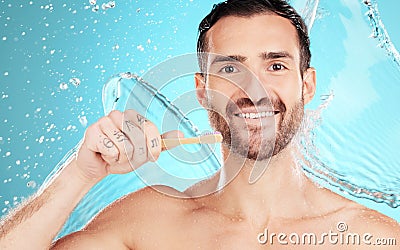 Eco friendly toothbrush, water and portrait of man on blue background for wellness, hygiene and brushing teeth. Cleaning Stock Photo