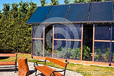 Eco glass house with solar panels Stock Photo