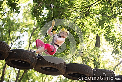 Eco Resort Activities. Climber little girl on training. Children fun. Rope park. Active children. Playground. Climber Stock Photo
