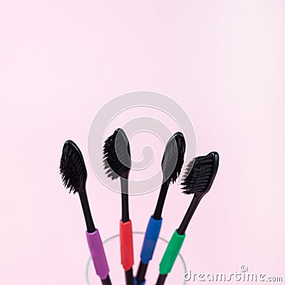 Eco toothbrushes made of bio degradable plastic and bamboo active charcoal on pink background Stock Photo