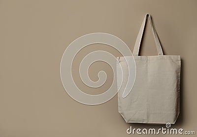 Eco tote bag hanging on color wall. Stock Photo