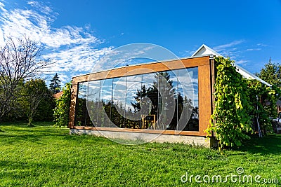 Ecologic building in the nature with huge windows in greeen Editorial Stock Photo