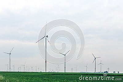 Ecological alternative power with windmill on the field Stock Photo