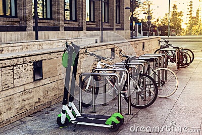 Ecological and personal transport in town. Bike and electric scooter Stock Photo