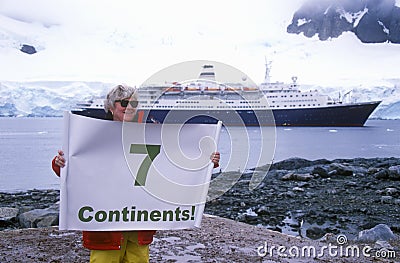 Ecological tourist from cruise ship Marco Polo with Seven Continents sign at Paradise Harbor, Antarctica Editorial Stock Photo