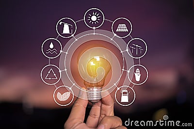 Ecology concept. Power energy in nature. hand holding lightbulb with solar with icons energy sources Stock Photo