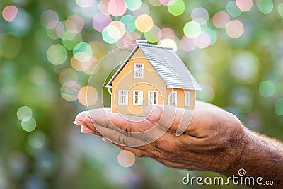 Ecology house in hands Stock Photo