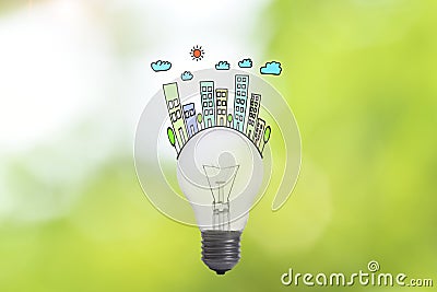 Ecology lightbulb concept house and family on green nature. Stock Photo