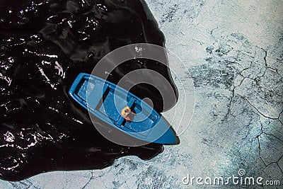 Ecology theme, water pollution, a man in a boat, top view Stock Photo