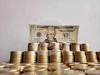 economic growth and trading, stacked mexican coins and american banknote of twenty dollars Stock Photo