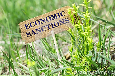 Economic sanctions wooden sign Stock Photo