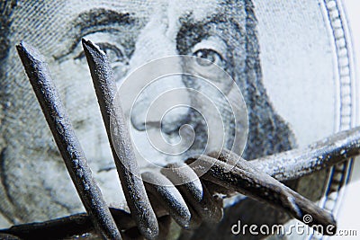 Economic warfare, sanctions and embargo busting concept. Close up barbed wire against US Dollar money Stock Photo