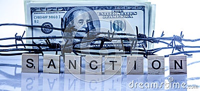 Economic warfare, sanctions and embargo busting concept. US Dollar money wrapped in barbed wire Stock Photo