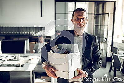 Economist leaving the office taking his box with things Stock Photo