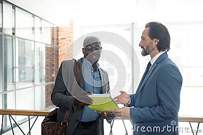 Dark-skinned economist speaking with businessman in the morning Stock Photo