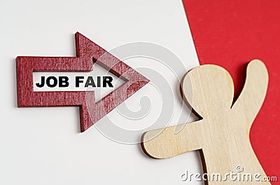 On a red-white surface, a human figure and an arrow with the inscription - JOB FAIR Stock Photo