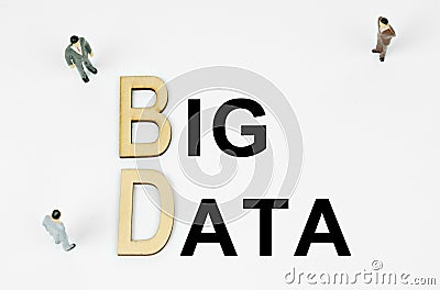 On a white background, figures of businessmen, wooden letters and the inscription - BIG DATA Stock Photo