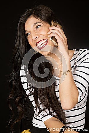 Ecstatic beautiful woman talking on her cell phone smiling Stock Photo