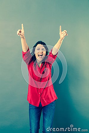 Ecstatic woman laughing with extrovert hand gesture Stock Photo