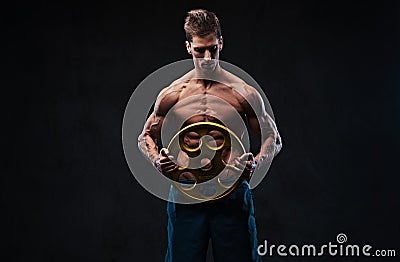 Ectomorph shirtless athletic male holds barbell weight. Stock Photo