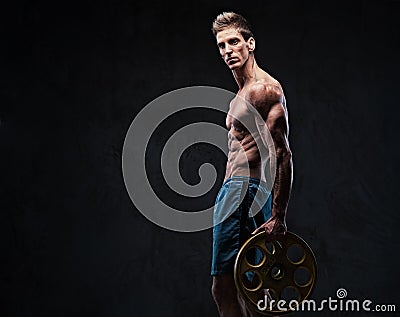 Ectomorph shirtless athletic male holds barbell weight. Stock Photo