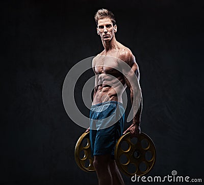 Ectomorph shirtless athletic male holds barbell weight. Stock Photo