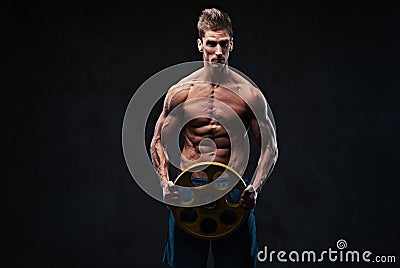 Ectomorph shirtless athletic male holds barbell weight. Stock Photo