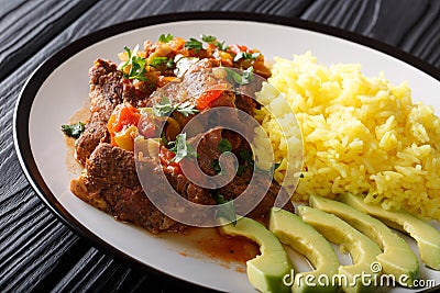 Ecuadorian seco de chivo goat meat with a garnish of yellow rice Stock Photo