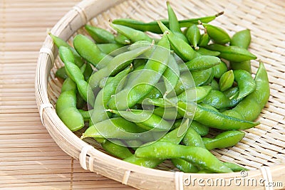 Edamame nibbles, boiled green soy beans Stock Photo