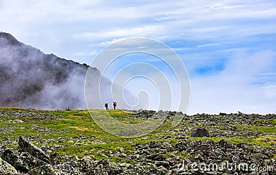 Edge world. Two men standing on edge of hanging valley Stock Photo