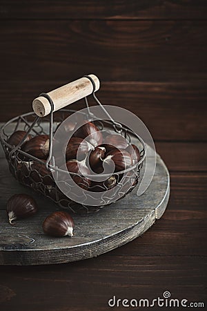 Edible chestnuts in a metal basket Stock Photo