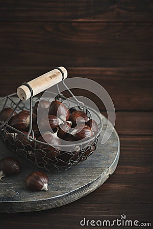 Edible chestnuts in a metal basket Stock Photo