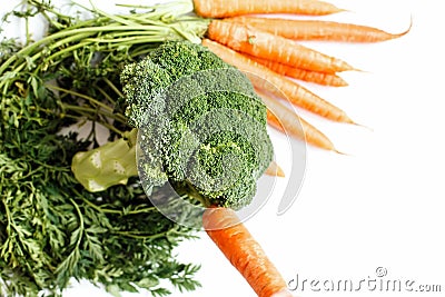 Edible still life. Broccoli and carrots are on the green Stock Photo