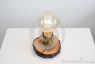 Edison lamp on bedside table near sofa in studio room Stock Photo