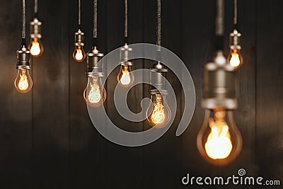 Edison light bulbs in front of a wooden wall Stock Photo