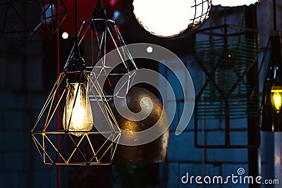 Edison`s light bulb and lamp in modern style. Warm tone light bulb lamp, loft lamps, vintage, retro style. Lamps in coffee shop. E Stock Photo