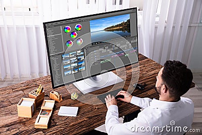 Editor Editing Video On Computer Stock Photo