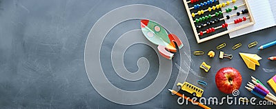 Education. Back to school concept. rocket cut from paper and painted over blackboard background. top view, flat lay Stock Photo