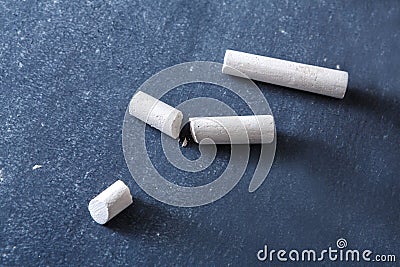 Education background, piece of chalk on blackboard Stock Photo