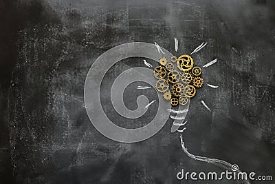 Education concept image. Creative idea and innovation. Vintage gears light bulb metaphor over blackboard Stock Photo