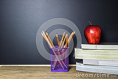 Education concept. Pencil on table and red apple on book. Stock Photo