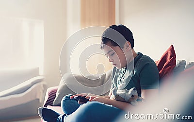 Education concept,School kid using mobile phone readying story from internet,Boy studying online learning at home,Child using cell Stock Photo