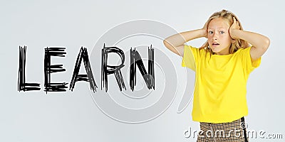 A teenager girl holding her head in surprise. Isolated background. The text is written next to it - LEARN Stock Photo