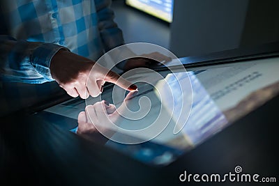 Woman hand using multimedia touchscreen display of interactive kiosk Stock Photo