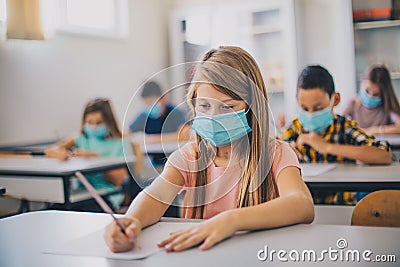 Teenagers students sitting in the classroom. Focus is on foreground Stock Photo