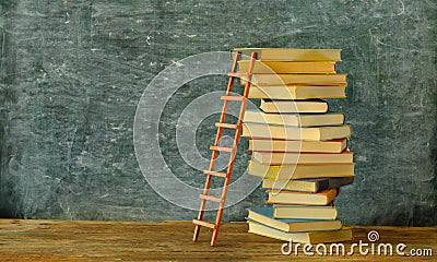 Education gives orientation,books,blackboard and ladder of success.Learning,knowledge,humanism, fight against fake news concept. Stock Photo