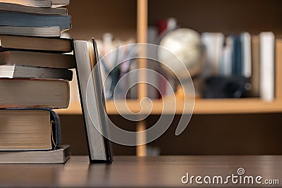 Education learning concept. Book in library with old open textbook, stack piles of literature text archive on reading desk, aisle Stock Photo